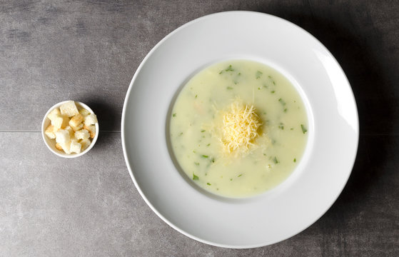 Cheese chicken soup with croutons in a white plate