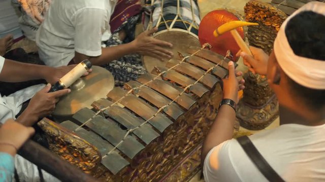 Asian People Playing Traditional Saron Javanese Gamelan Musical Instruments in Temple. Ubud, Bali, Indonesia. 4K.