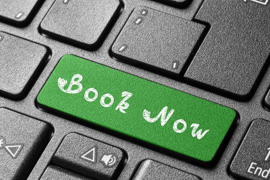 Written word Book Now on blue keyboard button