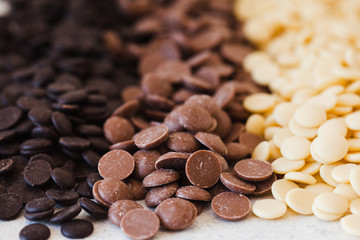 An assortment of fine white, dark, and milk chocolate in drops