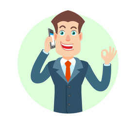 Businessman talking on mobile phone and showing a okay hand sign