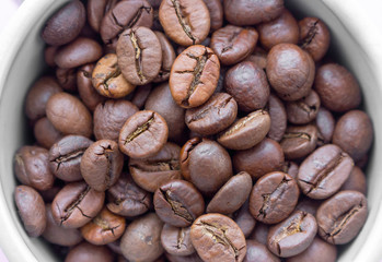 Brown coffee beans closeup. Aroma coffee. Espresso ingredient macro. Breakfast drink concept. Energy and cafe background. Roast coffee. 