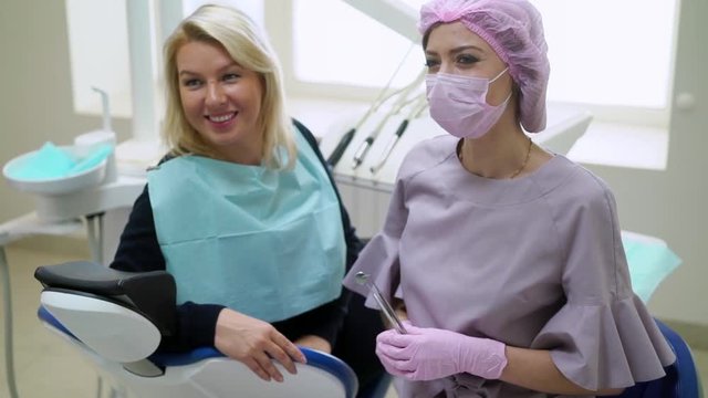Patient and dentist doctor in dental clinic smiling