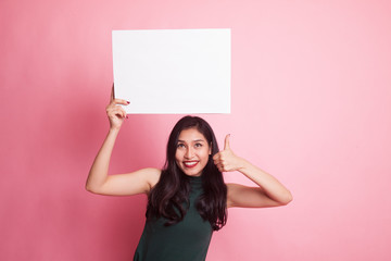 Young Asian woman show thumbs up with white blank sign.