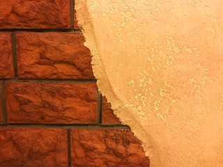 Creammy color half painted wall with the red brick as interior decoration