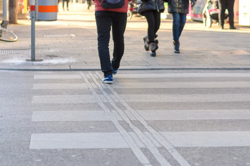 People crossing a zebra crossing in a street