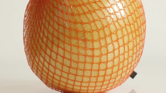 Big pomello on white background close-up footage - Packed Citrus maxima grandis fruit