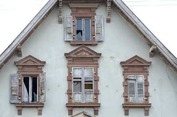 Fototapeta na wymiar End gable and windows of an old abandoned house