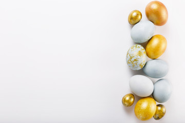 Easter background with Easter eggs and spring flowers. Top view with copy space