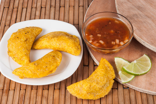 Colombian empanada with spicy sauce