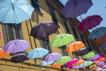 Fototapeta na wymiar Pietrasanta, Lucca: the main street with colorful umbrellas