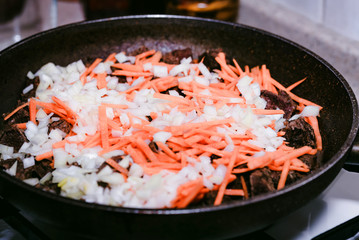 Beef stew with vegetables in frying pan