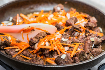 Beef stew with vegetables in frying pan