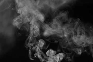 White smoke on a black background. Texture of smoke. Clubs of wh