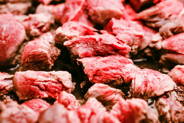Pieces of beef cooking in frying pan