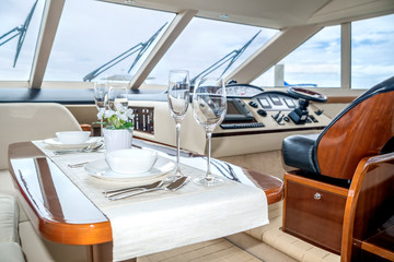 Luxury lunch table setting on a yacht interior comfortable design for holiday recreation tourism...