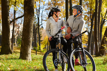 Fototapeta na wymiar backlight photo of a couple having fun by bike