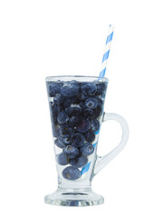 Blueberries in clear glass with water isolated on white background with clipping path copyspace.