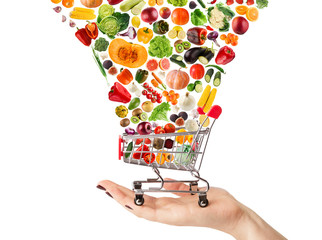 Collage of shopping cart with vegetables and fruits isolated on white.