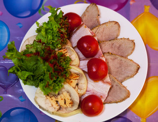 a festive snack. meat rifling decorated with tomatoes
