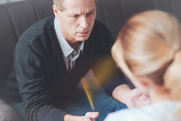 I am stressed out. Depressed stressed handsome man looking at his therapist and asking for professional help while having a psychological session