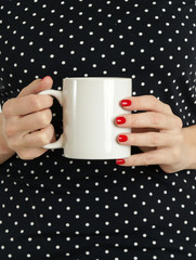 
Holding a cup of blank white mug