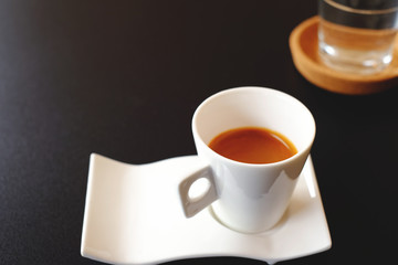 Hot espresso shot in white cup