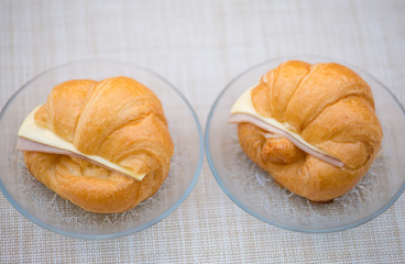 Ham and cheese sandwich croissant on glass dish