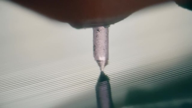 Macro shot of a vynil record player needle moving along the soundtrack