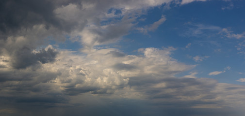 Landscape with dramatic light - beautiful golden sunset with saturated sky and clouds.
