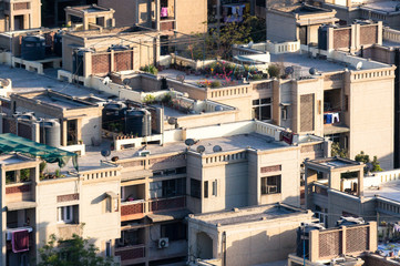 Fototapeta premium Concrete residential houses built to house the ever increasing population of Noida, Delhi. The windows, balconies and cityscape of the Delhi national capital region noida and gurgaon are visible