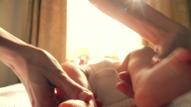 Mom touching newborn baby's feet