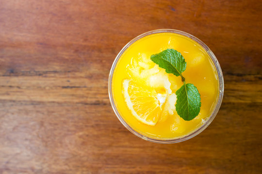 Orange juice blended in plastic cup. Freshness beverage. Tropical fruit.