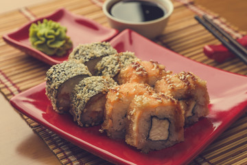 Sushi roll set in tempura and sticks with soy sauce