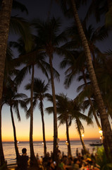 Fototapeta na wymiar Luxury tropical beach restaurant with people at sunset. Philippines