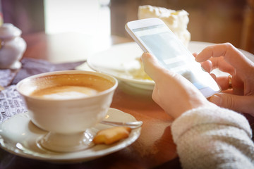 Woman using smart phone in the cafe