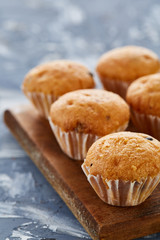 Top view close-up picture of tasty muffins on the cutting board, shallow depth of field, selective focus