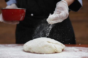 the cook makes flour for baking on the table