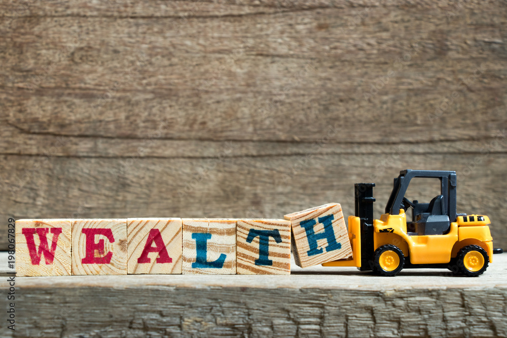 Poster Yellow toy forklift hold letter block H to complete word wealth on wood background