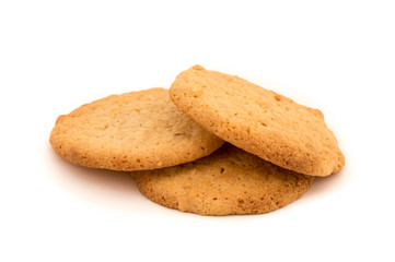 Three peanut butter cookies on a white background. Golden homemade biscuits fresh and reay to eat as a snack.