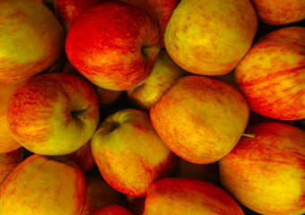 photo of freshly picked red apples in a wooden crate on the street market .