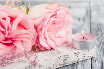 Pink gift box, roses, lit candle