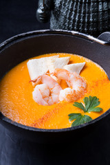 Orange asian seafood cream soup