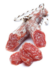 Dried organic salami sausage on white background