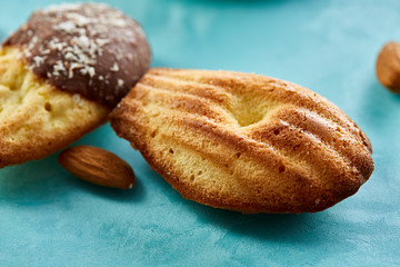 Fototapeta premium Yummy almond cookies arranged on blue background, close-up, selective focus, top view.