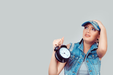 Afraid pretty woman with alarm clock