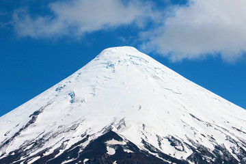 sorno Volcano closeup. Near the City of Puerto Varas, Chile.  Clouds with blue sky.