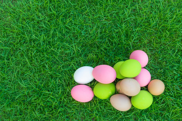 Fototapeta na wymiar Colorful Easter eggs in grass on green grass.