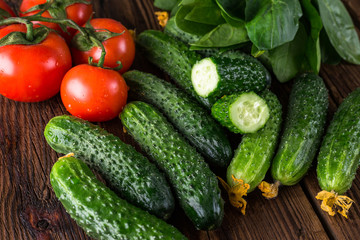cucumbers and tomatoes on a wooden table