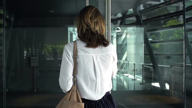 Young businesswoman entering office, super slow motion 120fps

